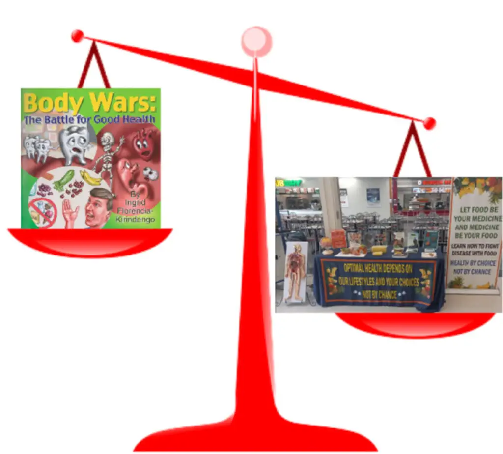 A scale with the cover to the book "body wars: the battle for good health" on one side and a family enrichment lifestyle changes pop up table on the other side.