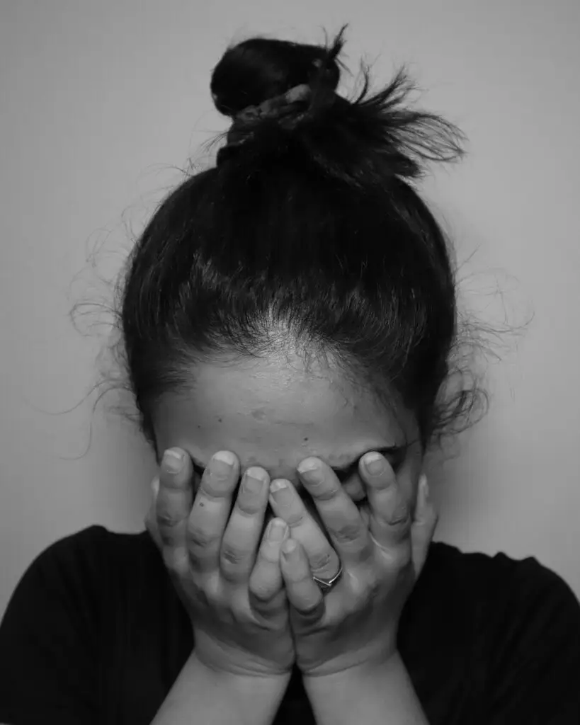 woman in distress burying face in hands